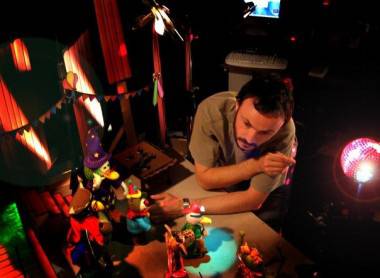 Photo: Christine Vestergaard. Still from 'Hana's Helpline' (Calon). Sometimes as an animator you will be expected to work with a number of puppets, as animator Ben is doing here. The skill is knowing sometimes how little to move something - a really key thing to understand in crowd scenes.