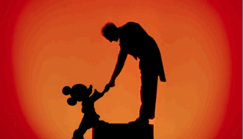 Mickey Mouse shaking hands with conductor Leopold Stokowski